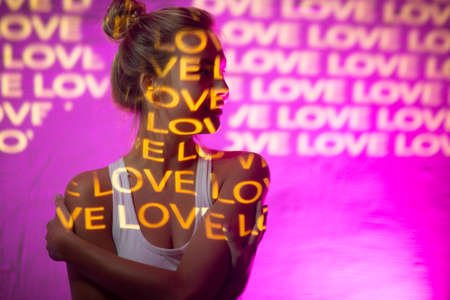 Young adult woman with word Love on her body.の写真素材
