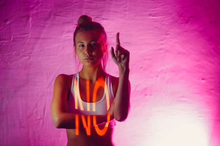 Young adult woman with word NO on her body.の写真素材