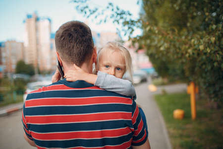 Rear view of father walking to Nursery school with his little daughterの写真素材