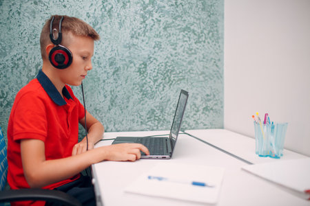 Young student boy with laptop learning and preparing back to school.の写真素材