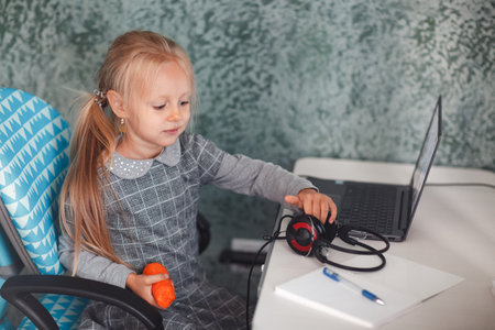 Young student little girl with laptop learning and preparing back to school.の写真素材