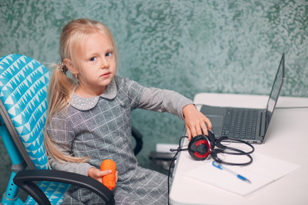 Young student little girl with laptop learning and preparing back to school.の写真素材