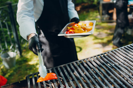 Hot open food catering grilled vegetables the waiter fries.の写真素材