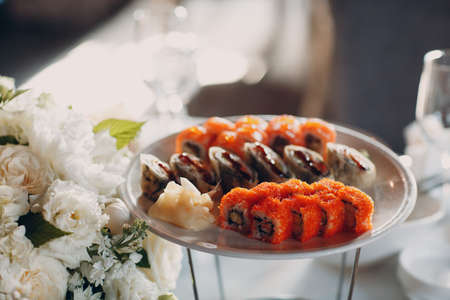 Japanese rolls and sushi on a plate in a restaurant catering party Concept.の写真素材