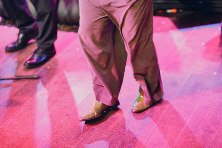 Close up legs clown feet with funny boots shoes and trousers.の写真素材