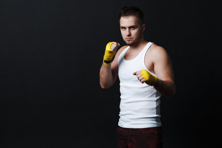 Man bare knuckle fighter stand at black background.の写真素材