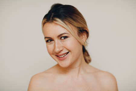Smiling young adult caucasian woman close up portrait with facial expressionsの写真素材