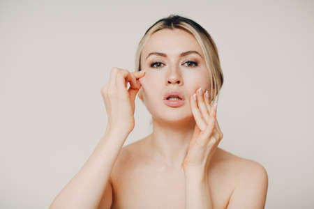 Young adult doing facial gymnastics self massage and rejuvenating exercises face building and liftingの写真素材