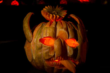 Halloween pumpkin head lantern with scary jack faces in dark.の写真素材