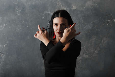 Young adult spanish woman dancing flamenco on grey vintage studio backgroundの写真素材