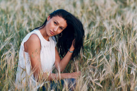 Woman farmer in the agricultural field at evening.の写真素材