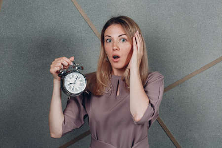 Business woman young adult coach with clock watch at office portrait. Time management conceptの写真素材