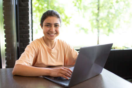 Indian business woman working on her laptop outdoor cafeの写真素材