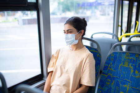 Indian Woman ride in public transport bus in medical face maskの写真素材