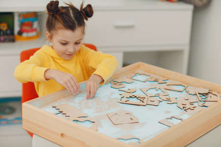 Baby girl playing with sand form toy. Early age education. Toddler cognitive psychology conceptの写真素材