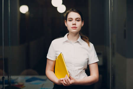 Business woman portrait in white shirt stand at office.の写真素材
