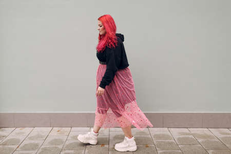 Plus size overweight fat body positive lgbtq woman with red hair and pink glasses.の写真素材