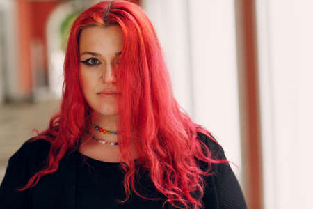 European plus size woman portrait outdoor street city. Young red pink haired body positive girl.の写真素材