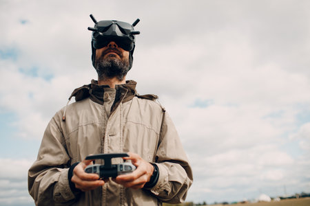Man controlling quadcopter drone for aerial photography and videography with goggles antenna remote controller padの写真素材