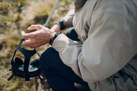 Man checking quadcopter drone for aerial photography and videography with goggles antenna remote controller.の写真素材