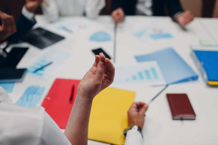 Businessman and businesswoman team meditate and holds hands each other after office meeting. Business people group conference discussion meditation conceptの写真素材