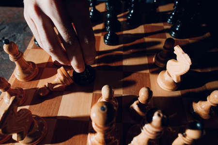 Young adult man play chess in darkの写真素材