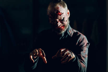 Zombie man portrait in darkness with makeup for halloween partyの写真素材