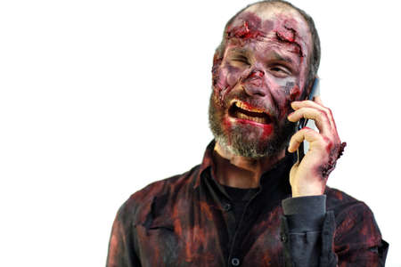 Zombie male speaking mobile phone on white background halloween conceptの写真素材