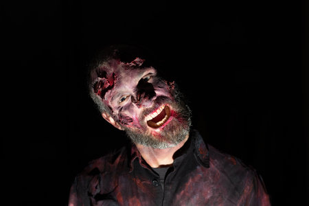 Zombie man portrait in darkness with makeup for halloween partyの写真素材