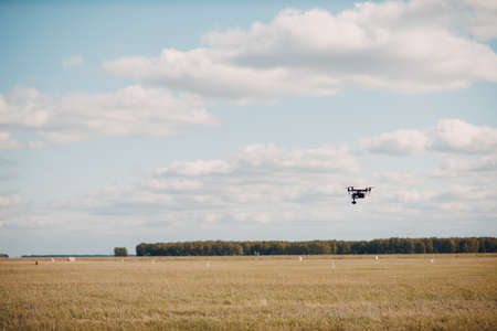 Big quadcopter drone on aerial flight and filming.の写真素材