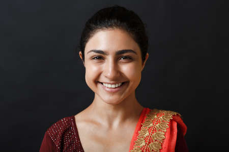 Portrait of young adult indian woman in sari. Smiling face.の写真素材