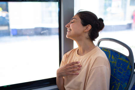 Indian Smiling Woman ride in public transport bus or tramの写真素材