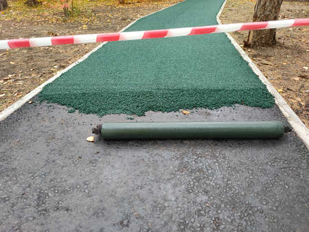 Treadmill rubber coating in park. Soft coating for jogging and running. Seamless rubber coating of crumb rubber.の写真素材