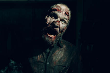 Zombie male makeup for halloween concept. Make up skin and blood faceの写真素材