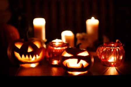 Halloween pumpkin Jack-o-lantern. Pumkins and candles on table.の写真素材