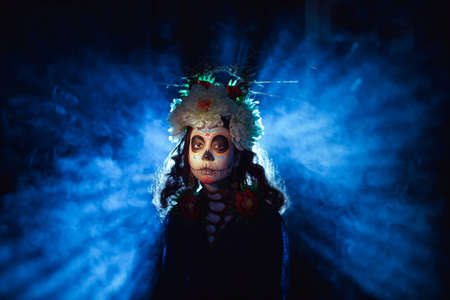 Woman with mexican skull halloween makeup on face. Day of the dead aka Dia de los Muertos and halloween party concept.の写真素材