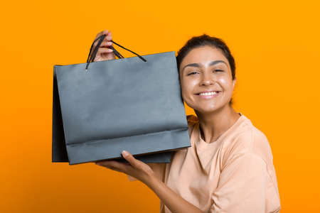 Indian woman holds shopping bags in hands. Sale and Black Friday conceptの写真素材
