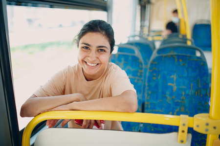 Indian Young 20-25 years Woman ride in public transport bus or tramの写真素材