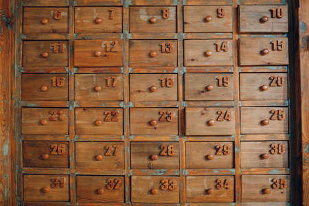 Background texture wallpaper old vintage wooden cabinet with lockers drawers file boxes.の写真素材