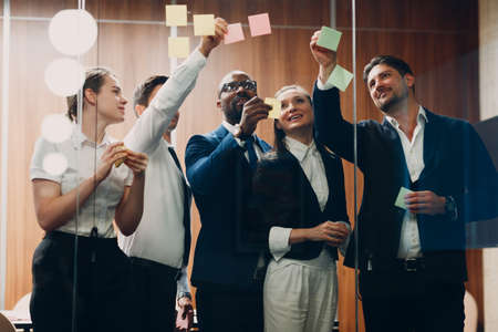 Business office team people molded on glass sticky note stickers.の写真素材