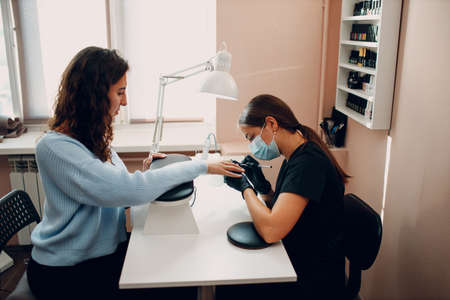 Manicure process female hands finger nails polish.の写真素材