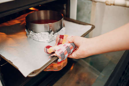 Pastry chef makes delicious red velvet cake. Cooking in oven cake base.の写真素材
