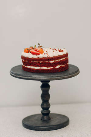 Pastry chef makes delicious red velvet cake. Cooking and decorating dessert.の写真素材