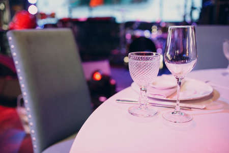 beautiful shape empty wine glass on table in restaurant decor.