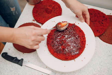 Pastry chef makes delicious red velvet cake. Cooking and decorating dessert.の写真素材
