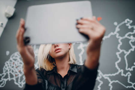 Young woman using digital tablet indoor. Social media and using technology concept.の写真素材