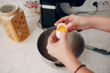 Pastry chef makes cake. Cooking and beat eggs.の写真素材