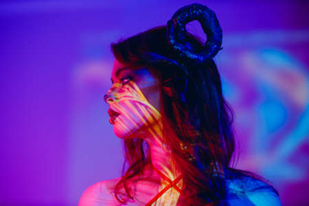 Beautiful young woman with makeup zodiac signs of Capricorn or Aries or Taurus. Girl with horns on...