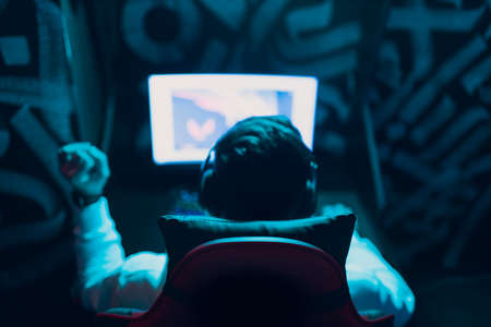 Guy playing gaming game on computer at game club.