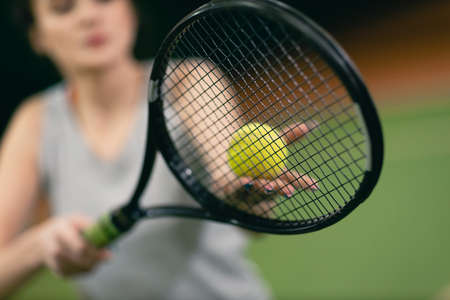 Tennis woman player playing training with racket and ball at court.の写真素材